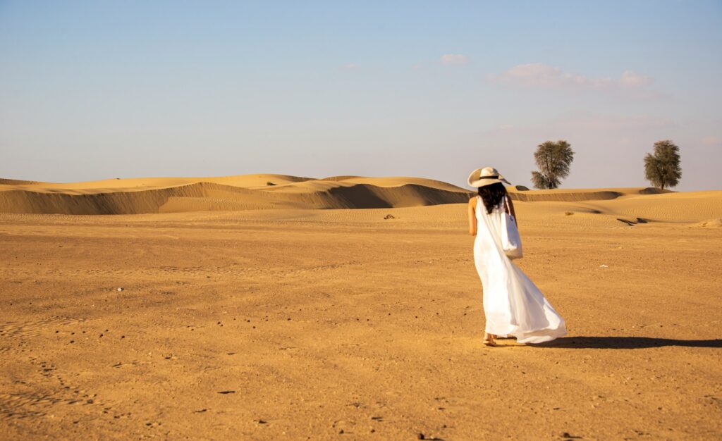Woman wearing a white dress in the desert